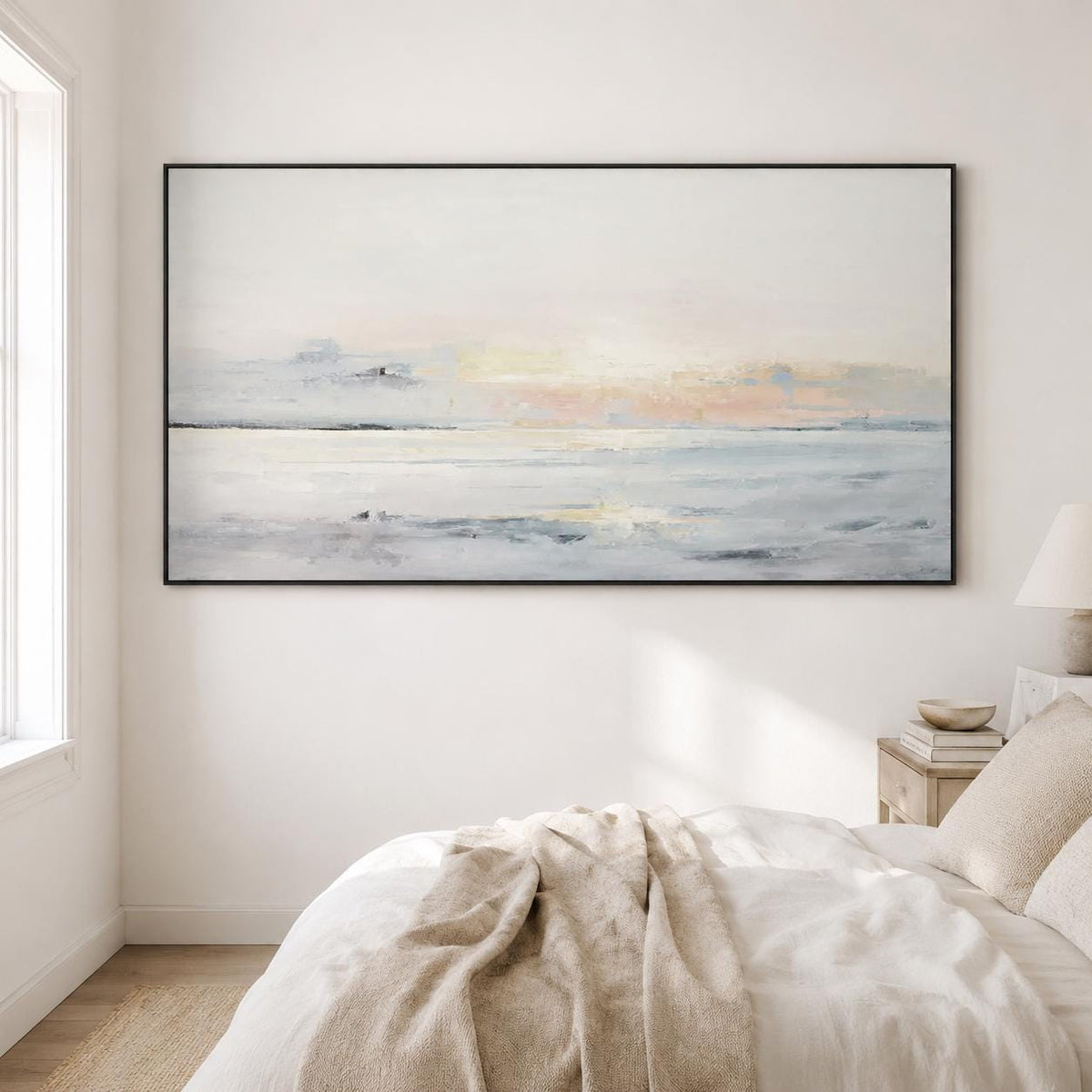 May include: Abstract landscape painting in a black frame. The artwork features a serene seascape with soft pastel colors of white, blue, and peach. The painting evokes a sense of calm and tranquility, perfect for home decor.