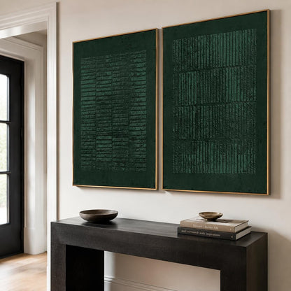 May include: Two rectangular wall art pieces in deep forest green, each framed in a thin gold border. The artwork features a textured, raised pattern of vertical and horizontal lines, creating a grid-like effect across the dark green surface.