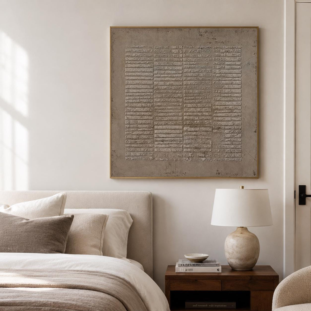 May include: A square wall art piece featuring a textured, monochromatic taupe surface with a grid of horizontal, raised rectangular segments. The artwork is framed in a thin, metallic gold border and displays a weathered, industrial appearance.