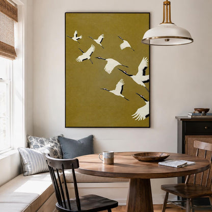 May include: A rectangular wall art print featuring a mustard yellow background with a flock of white cranes in flight. The birds are depicted with black wingtips and long necks, arranged in a diagonal formation across the vertical canvas.