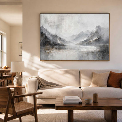 May include: A large rectangular wall art piece featuring an abstract landscape painting in shades of gray, white, and black. The artwork depicts a mountain range with textured brushstrokes, creating a misty, atmospheric scene above a calm body of water.