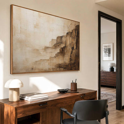May include: A large rectangular wall art piece featuring an abstract landscape in shades of beige, cream, and dark brown. The painting displays textured, layered brushstrokes that suggest a rocky cliffside or canyon formation within a frame.