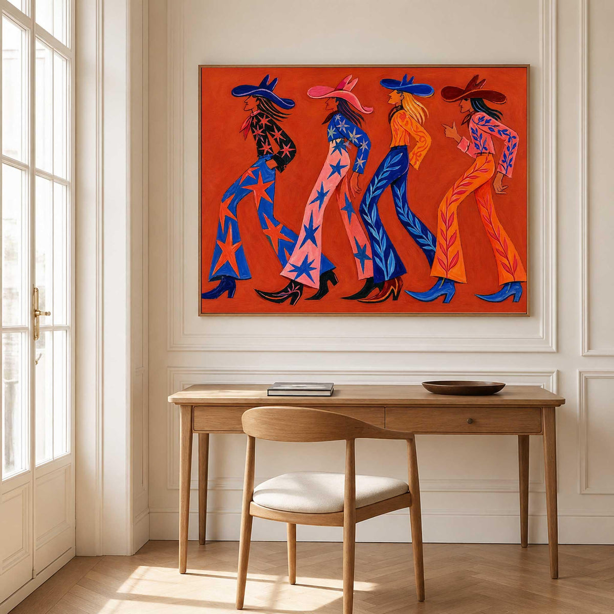 May include: A rectangular wall art print featuring four figures walking in profile against a solid orange background. Each figure wears a wide-brimmed hat, a long-sleeved top, and flared trousers decorated with star or leaf patterns, finished with pointed boots.