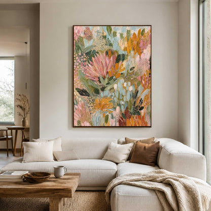 May include: A large rectangular canvas painting featuring an abstract floral composition with layered brushstrokes in shades of soft pink, muted orange, sage green, and cream, displayed on a light-colored wall above a white sectional sofa.