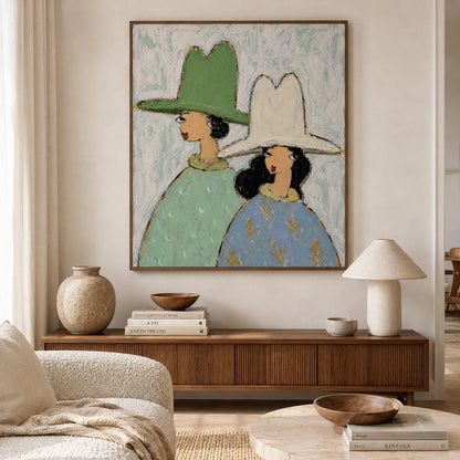 May include: A framed wall art painting depicting two figures wearing wide-brimmed hats. One figure wears a green hat and a light green patterned top, while the other wears a white hat and a blue top with gold accents against a textured background.