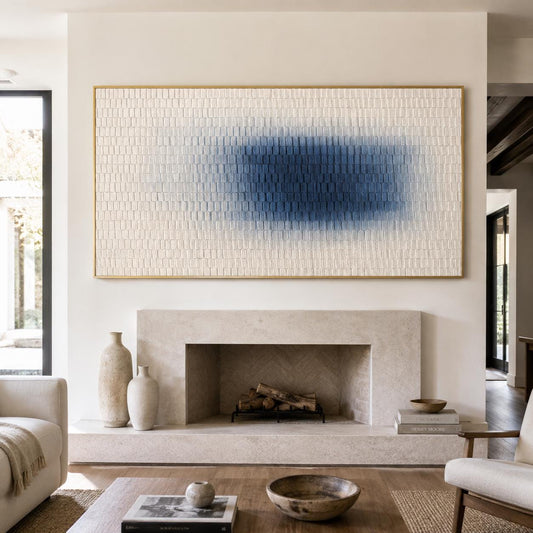 May include: A large rectangular wall art piece featuring a textured cream-colored surface with a central horizontal gradient of deep blue paint. The artwork is enclosed in a thin gold frame and displays a repeating pattern of small raised square blocks.