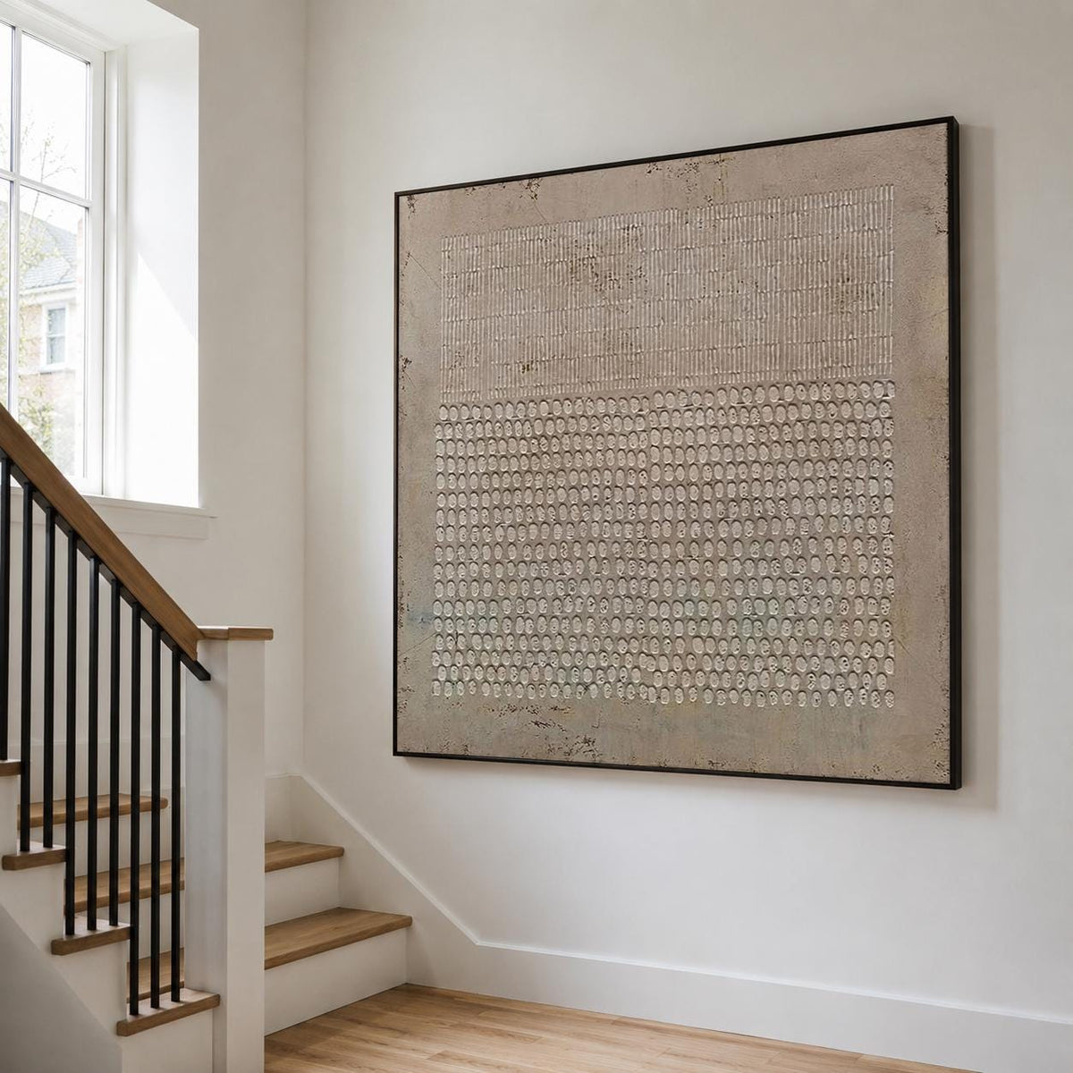 May include: A large square wall art piece featuring a textured beige and taupe surface. The upper section displays vertical line patterns, while the lower section consists of a dense grid of raised circular shapes, all framed in a thin black border.