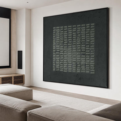 May include: A large, rectangular wall art piece featuring a dark charcoal gray background with a central square composed of a grid of raised, textured, light gray rectangular blocks, all enclosed within a thin, black frame.
