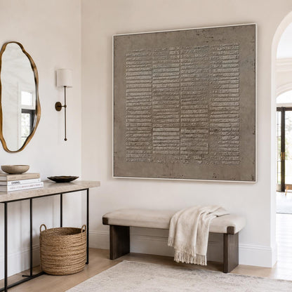 May include: A large square wall art piece featuring a textured taupe surface with horizontal raised lines, framed in a thin white border. The artwork displays a grid-like pattern of embossed rectangular segments across the entire canvas.