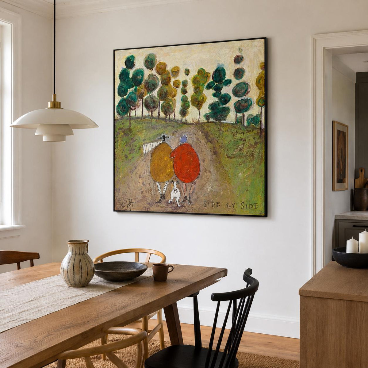 May include: A square framed painting featuring two figures in yellow and red coats walking with a small white dog on a dirt path through a green landscape with stylized trees. The text SIDE BY SIDE is printed in the lower right corner of the canvas.