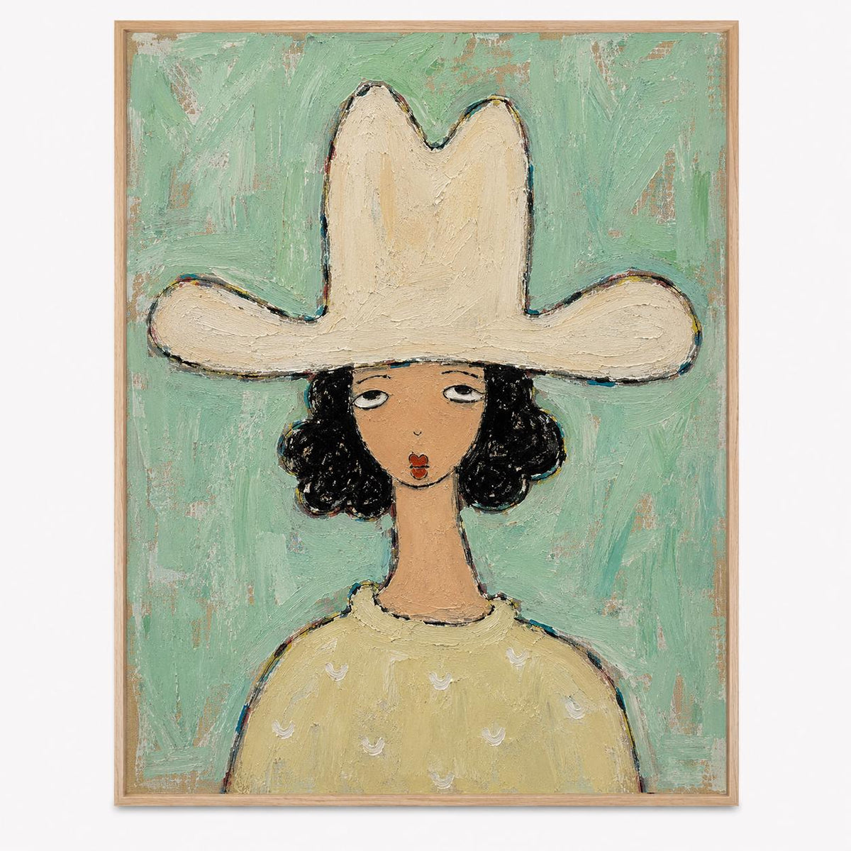 May include: A framed oil painting on canvas depicting a figure wearing a large cream-colored cowboy hat. The figure has dark curly hair, a tan complexion, and a light yellow sweater. The background is a textured, light mint green color.