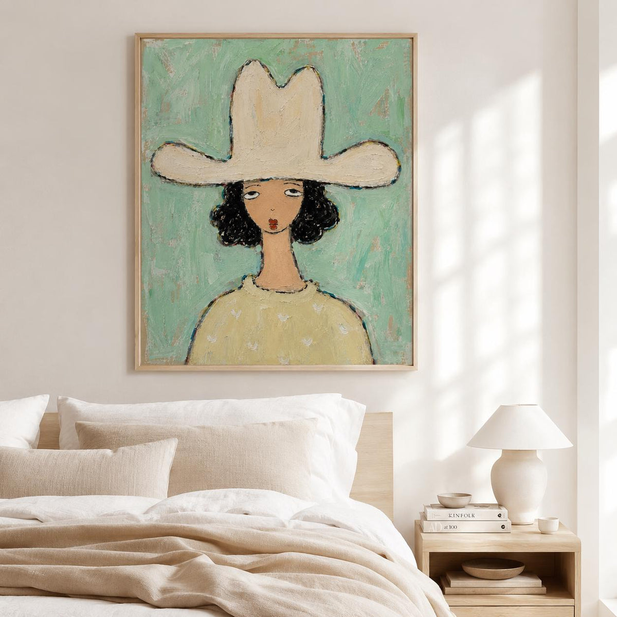 May include: A framed wall art print featuring a stylized illustration of a person with dark curly hair wearing a wide-brimmed cream-colored hat and a pale yellow sweater, set against a textured mint green background with visible brushstroke details.