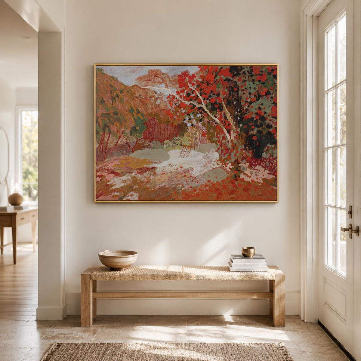 May include: A rectangular landscape painting in a thin gold frame featuring an autumn forest scene with vibrant red, orange, and green foliage, textured brushstrokes, and a light-colored path winding through the trees under a soft sky.