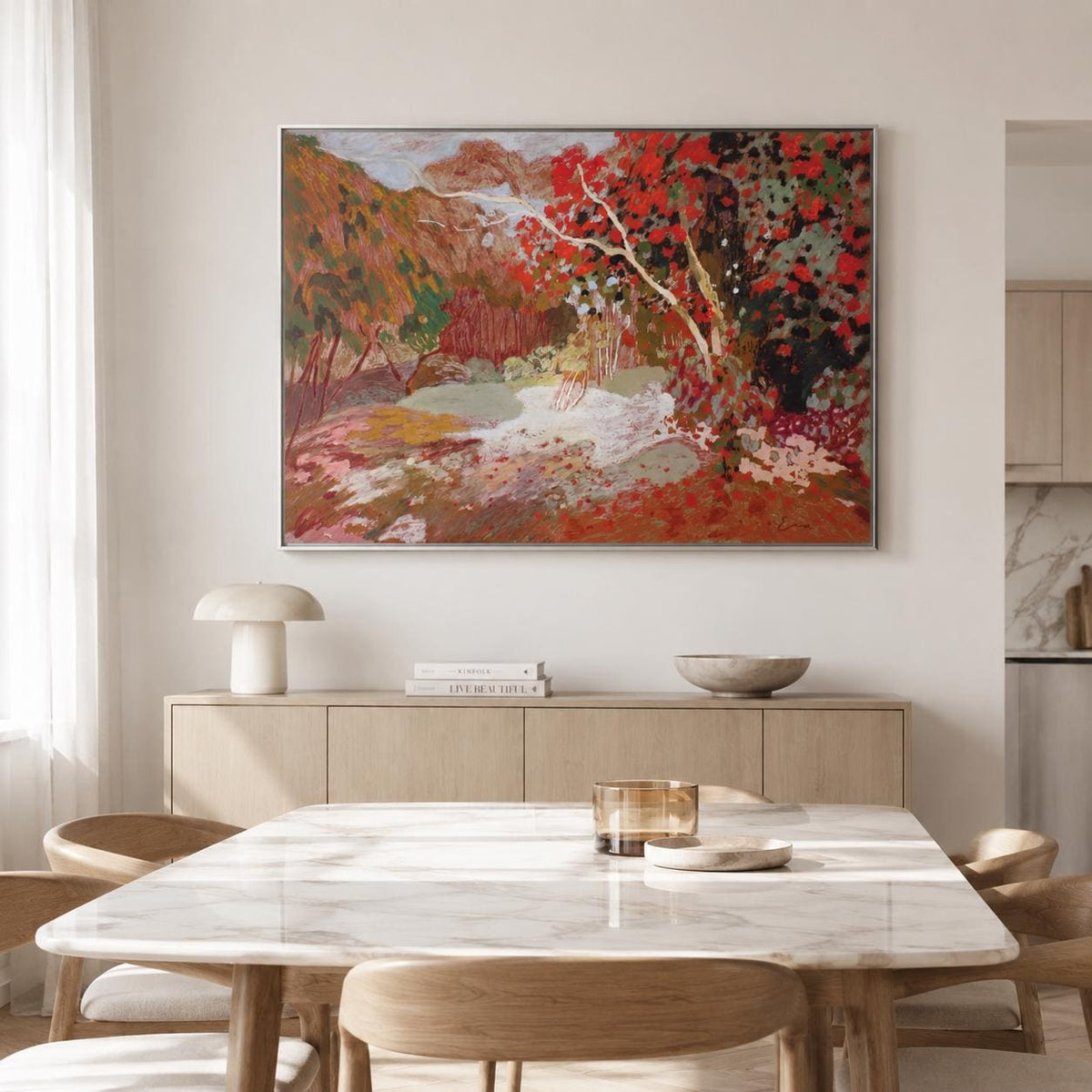May include: A large rectangular framed painting hanging on a wall, depicting an impressionistic landscape with vibrant red foliage, earthy brown hills, and a pale central area, rendered in thick, textured brushstrokes with a rich color palette.