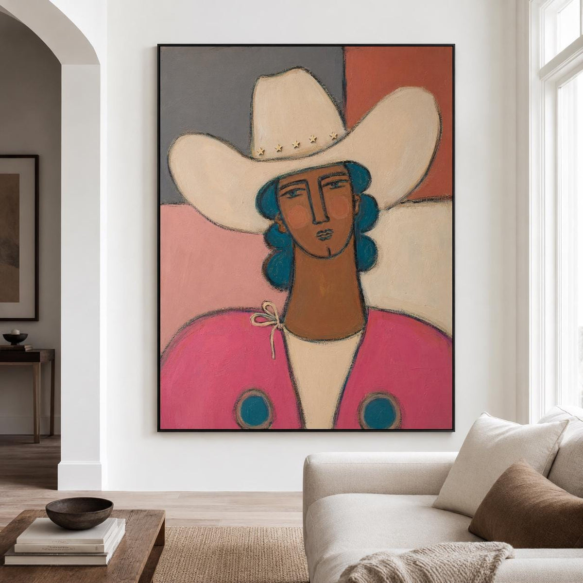 May include: A framed painting depicting a person wearing a cream-colored cowboy hat with star accents and blue hair. The figure has brown skin and wears a bright pink jacket with blue circular details over a cream shirt against a color-blocked background.