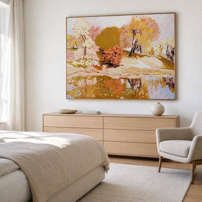 May include: A large rectangular landscape painting in a thin wooden frame, featuring an impressionistic scene of trees in shades of yellow, orange, and green reflected in a body of water, displayed on a plain white wall above a wooden dresser.