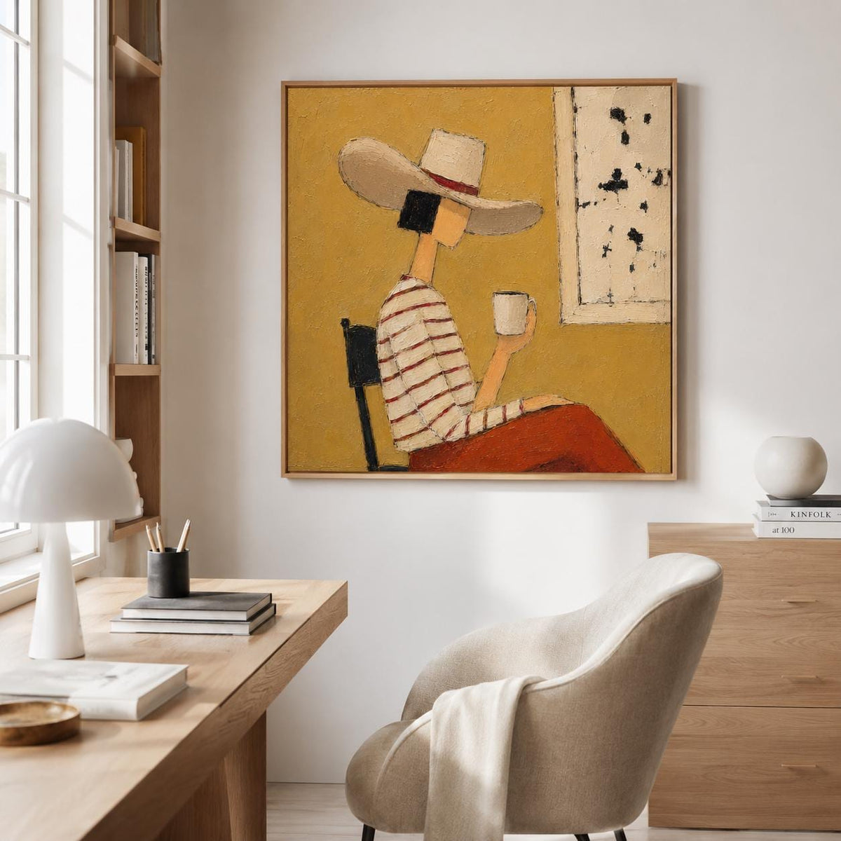 May include: A square framed painting featuring a stylized figure wearing a wide-brimmed hat and a striped long-sleeve shirt, sitting on a chair while holding a white mug. The background is a solid mustard yellow with a rectangular white panel.