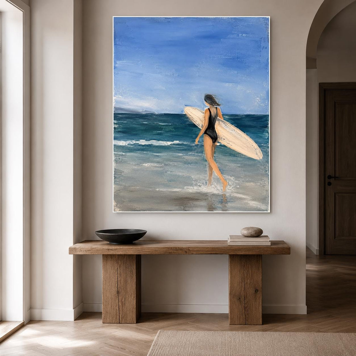 May include: A vertical oil painting on canvas depicting a person in a black swimsuit walking into the ocean while carrying a light-colored surfboard. The scene features a deep blue sky, dark teal waves, and a sandy shoreline with visible brushstrokes.