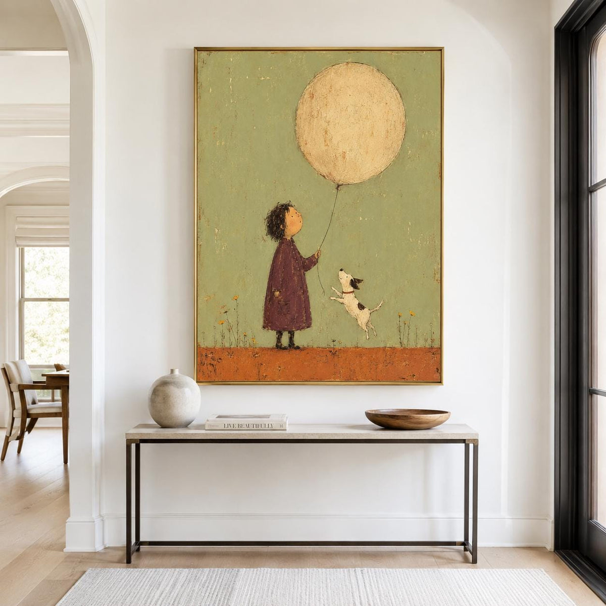 May include: A framed wall art print featuring a child in a dark purple coat holding a large, round, cream-colored balloon. A small white dog with black spots jumps toward the balloon against a muted sage green background and a textured orange ground.
