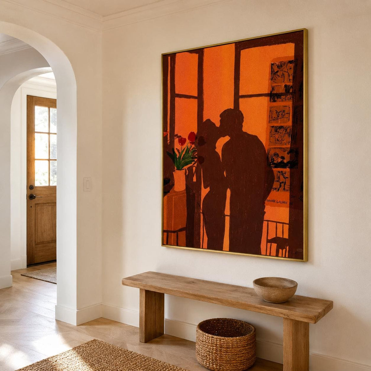 May include: A large rectangular wall art piece in a gold frame featuring a dark brown silhouette of two people kissing against a vibrant orange background. The artwork includes a small vase with red flowers and a vertical panel with black sketches.