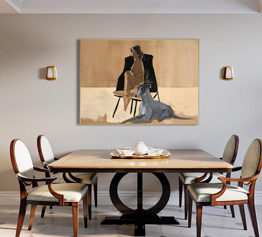 May include: A rectangular wall art piece featuring a painting of a seated figure in a black jacket and a grey dog lying on the floor. The artwork uses a neutral color palette of beige, tan, black, and grey, presented in a simple frame.