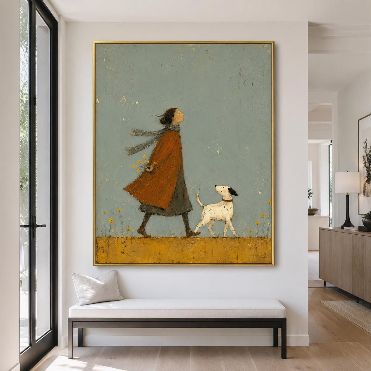 May include: A framed wall art print featuring a stylized illustration of a person in a long orange coat and a grey scarf walking with a small white dog with black spots. The scene is set against a muted sage green background with yellow flowers.