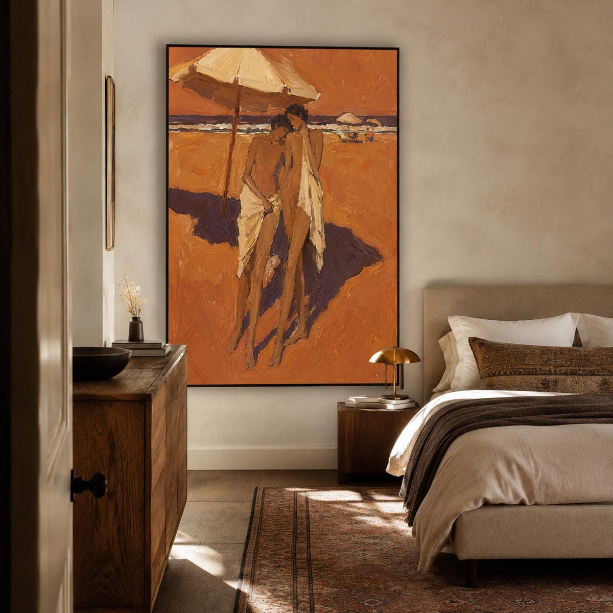 May include: A large rectangular framed wall art piece featuring an oil painting of two figures standing on a sandy beach under a large umbrella. The scene is rendered in warm orange and brown tones with deep purple shadows cast on the sand.