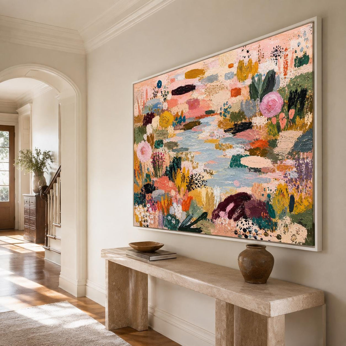 May include: A large rectangular framed canvas painting featuring an abstract landscape with a central light blue water feature surrounded by textured brushstrokes in shades of pink, yellow, orange, dark green, and black, hanging on a wall.