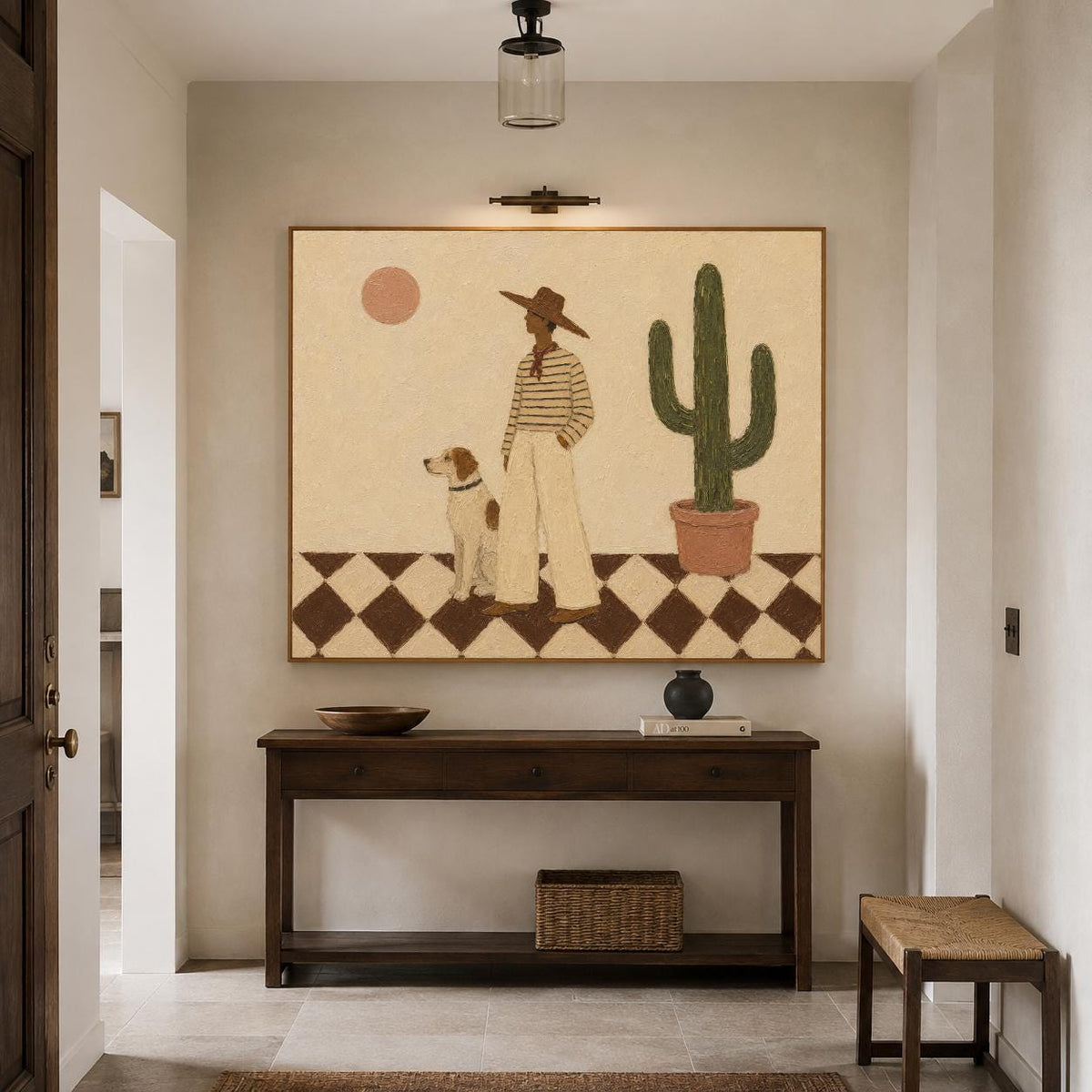 May include: A rectangular wall art print featuring a person in a wide-brimmed hat and striped shirt standing with a dog on a black and white checkered floor. A tall green cactus in a terracotta pot and a pale pink sun are visible in the background.