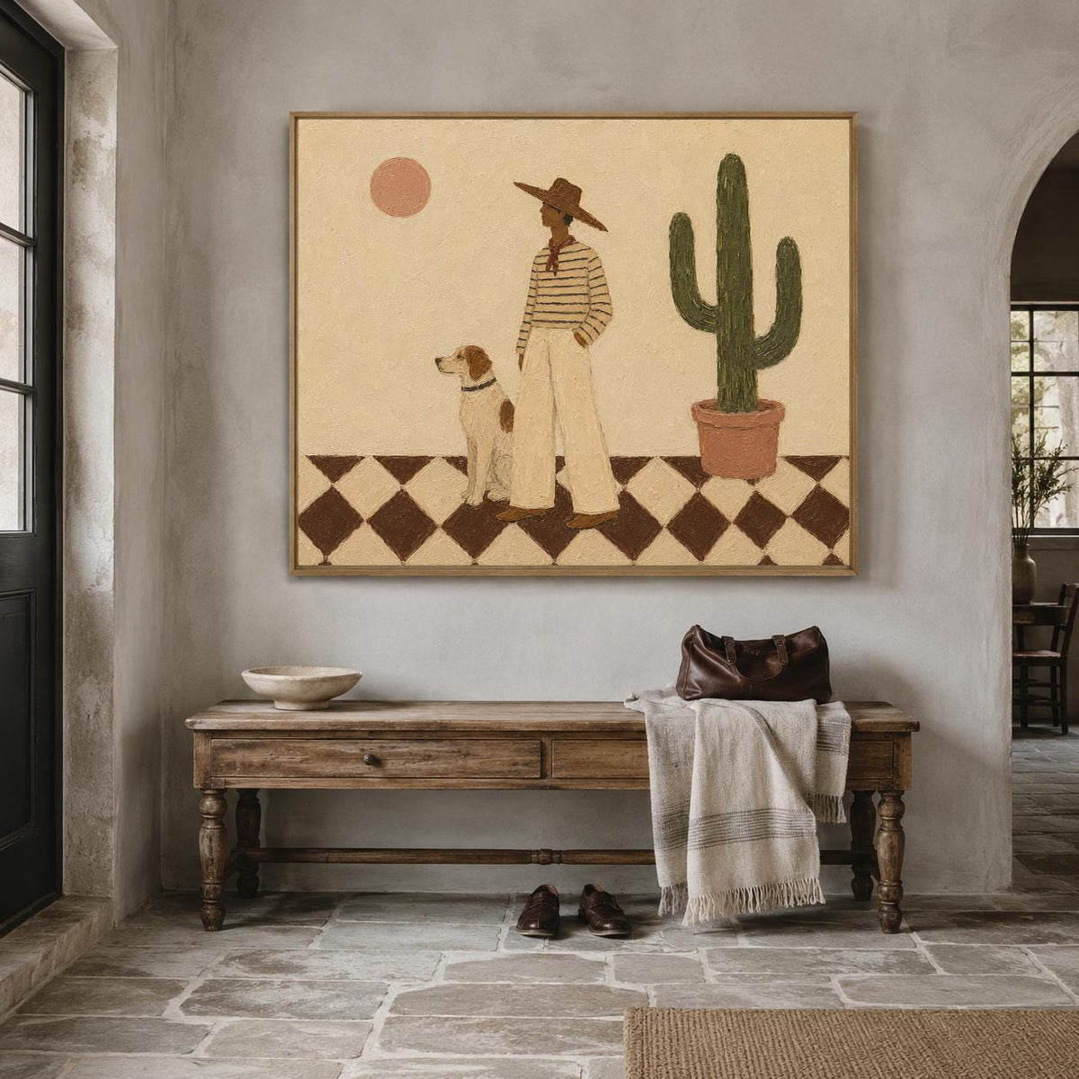 May include: A rectangular wall art print featuring a desert scene with a person in a wide-brimmed hat and striped shirt standing next to a dog on a brown and cream checkered floor. A tall green cactus in a terracotta pot and a sun are visible.