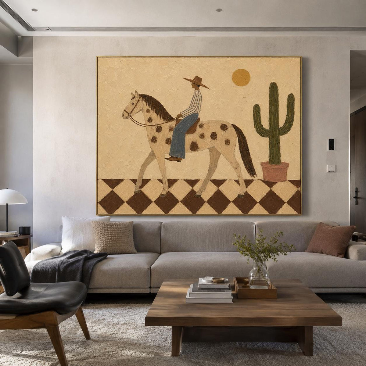 May include: A large rectangular wall painting featuring a person in a hat and striped shirt riding a spotted horse across a brown and white checkered floor. A green cactus in a pot and a yellow sun are visible against a beige background.