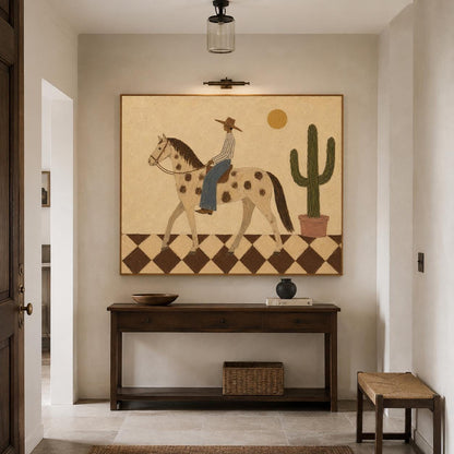 May include: A rectangular wall art piece featuring a painting of a person in a hat riding a spotted horse across a checkered floor. A tall green cactus in a pot stands to the right, and a yellow sun is positioned in the upper right corner.