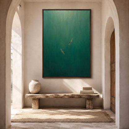 May include: A large rectangular wall art piece featuring a deep green underwater scene with two small figures swimming downward. The artwork is framed in a dark wood border and is mounted on a light-colored wall above a rustic wooden bench.