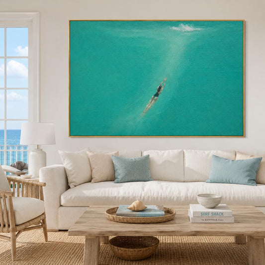 May include: A large rectangular wall art piece featuring an aerial view of a person swimming in vibrant turquoise ocean water. The swimmer is positioned in the center, moving through the clear sea, with a small white splash visible at the top.