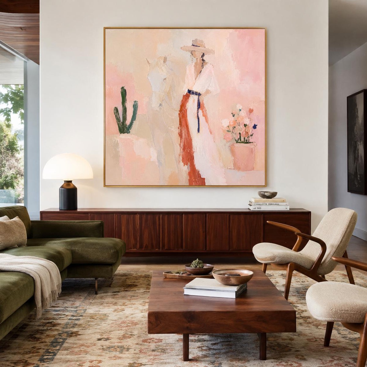 May include: A large square canvas painting featuring a person wearing a wide-brimmed hat and a long dress with a dark belt, standing beside a white horse, a green cactus, and a potted plant, all rendered in soft shades of pink and peach.