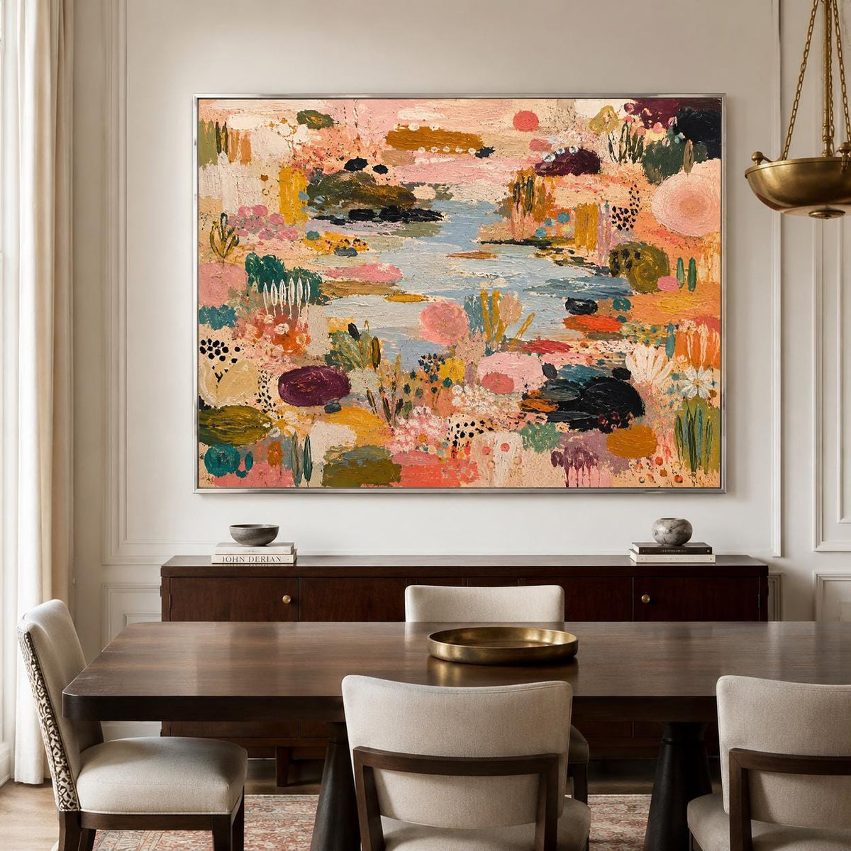 May include: A large rectangular canvas painting featuring an abstract landscape with a central blue water feature surrounded by textured patches of pink, orange, yellow, green, and black paint, framed in a thin silver metal border.