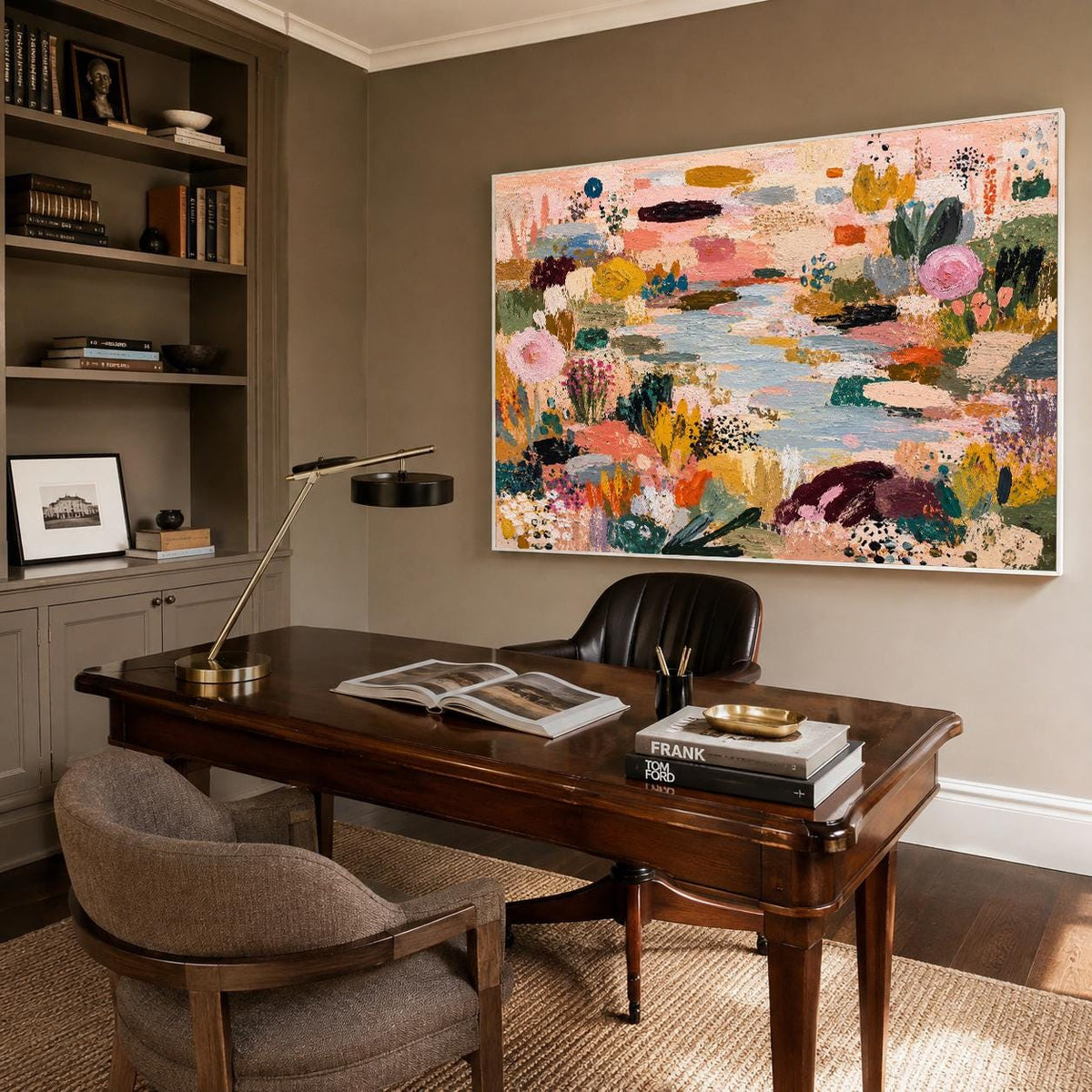 May include: A large rectangular abstract painting featuring a vibrant landscape with textured brushstrokes in shades of pink, yellow, green, blue, and deep purple, displayed in a white frame on a wall above a dark wooden desk and office chair.