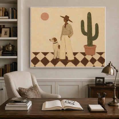 May include: A framed wall art print featuring a person in a wide-brimmed hat, striped shirt, and light pants standing next to a dog on a brown and white checkered floor. A tall green cactus in a pot and a round sun are set against a beige background.