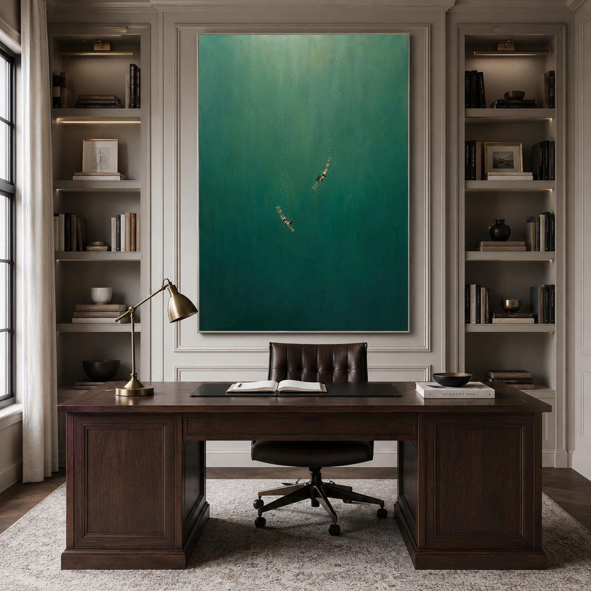 May include: A large rectangular wall art piece featuring a deep emerald green gradient background with two small, indistinct figures swimming in the center. The artwork is displayed above a dark wood desk with a brass lamp and a leather chair.