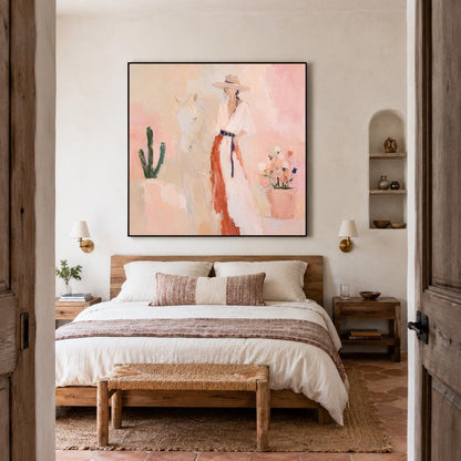 May include: A square wall art print featuring an impressionistic painting of a person wearing a wide-brimmed hat and a long, flowing dress with a dark belt. The scene includes a cactus and a potted plant against a soft, peach-toned background.
